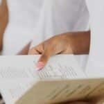 Close-up of a woman's hands holding a wedding ceremony program.