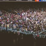 A vibrant crowd fills a football stadium during a lively match.