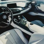 Explore the sophisticated interior of a BMW i8 sports car featuring sleek design and premium materials.