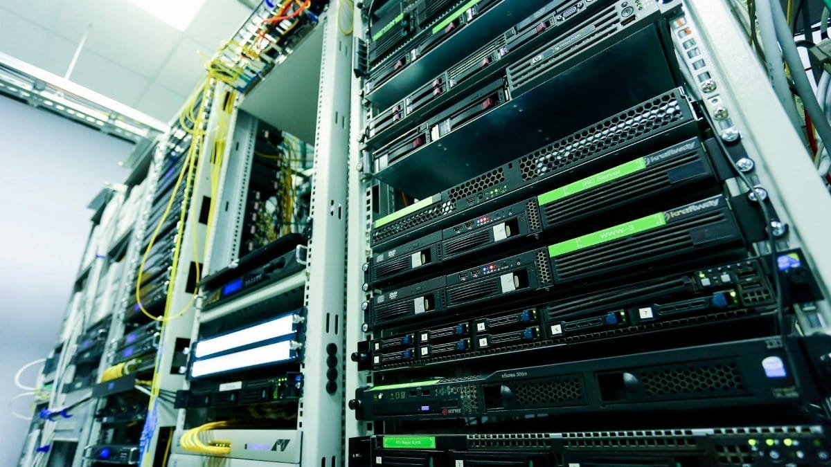 High-tech server rack in a secure data center with network cables and hardware components.