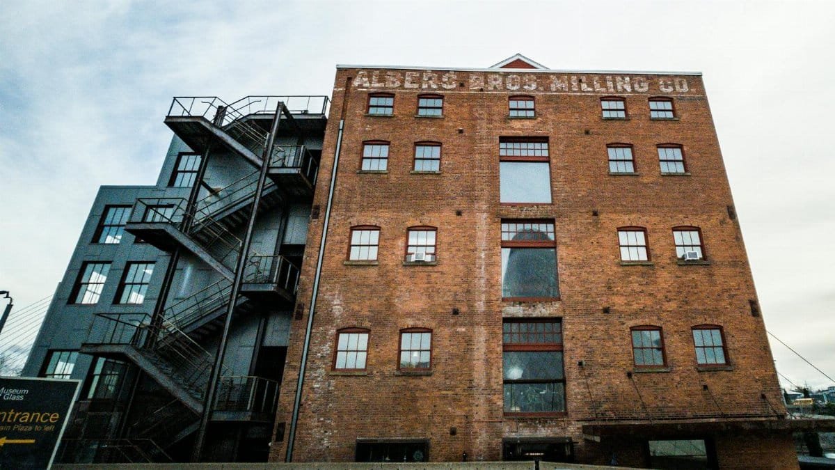 Low angle view of the Albers Bros Milling Co building, showcasing industrial charm and architectural detail.