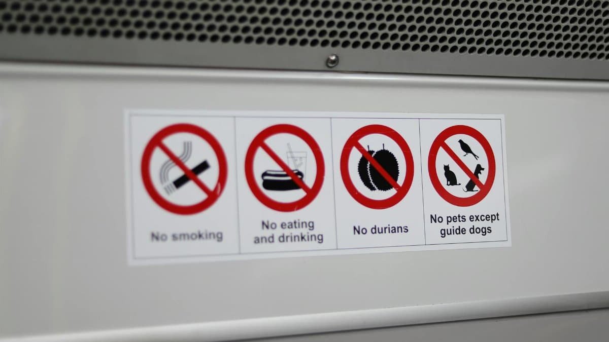 Close-up of various prohibition signs including no smoking and no durians.