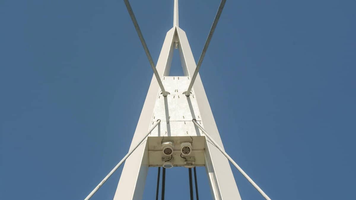 Close-up of a modern bridge's architectural symmetry against a blue sky.