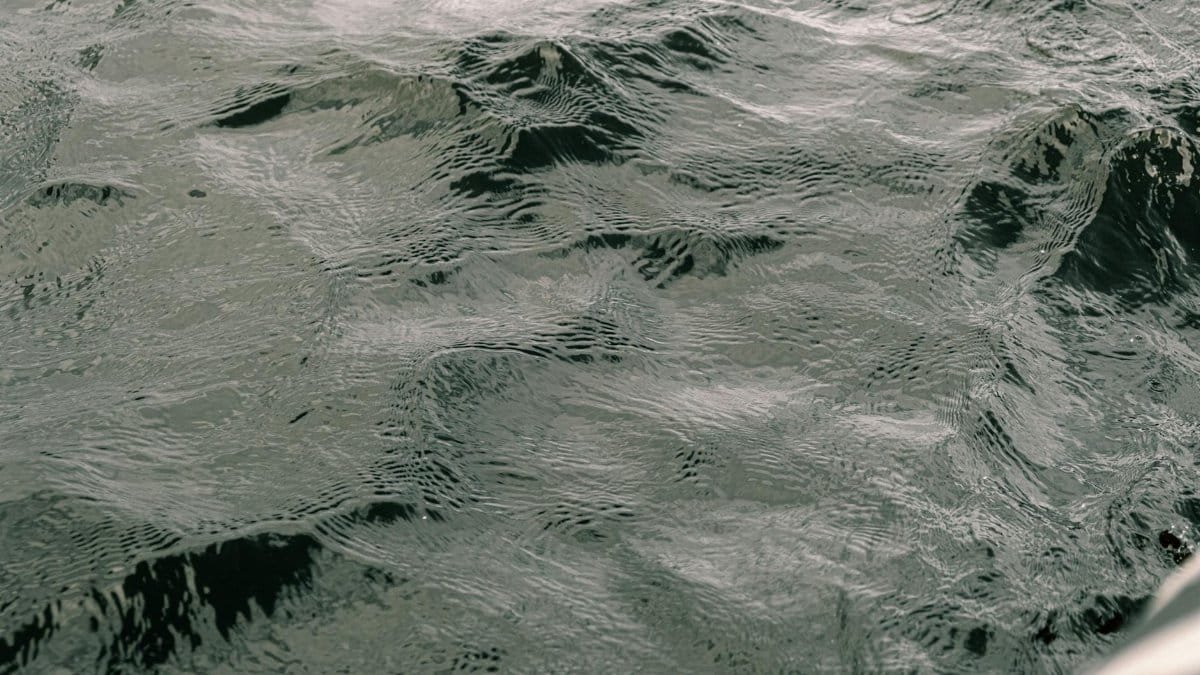 Calm ocean water with gentle ripples creating a serene and textured pattern.