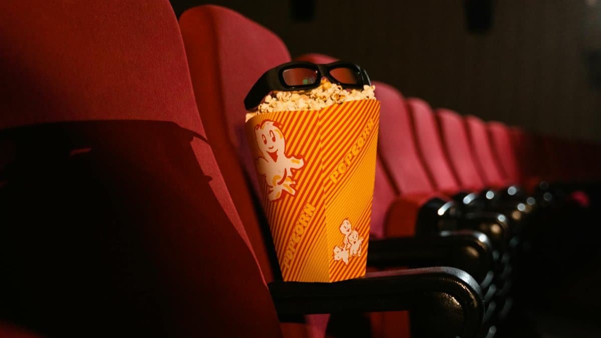 Cinema seat with popcorn and 3D glasses perfectly capturing the movie theater experience.