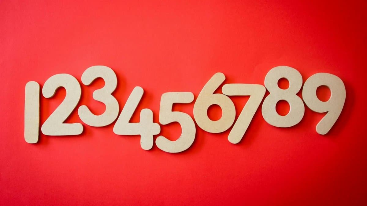 Creative display of numbers one to nine on a vibrant red background, ideal for educational materials.