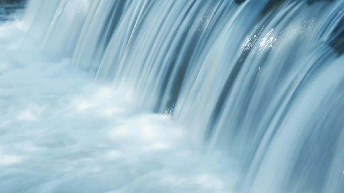 Gentle waterfall cascading in Oberwart, Austria, conveying tranquility and natural beauty.