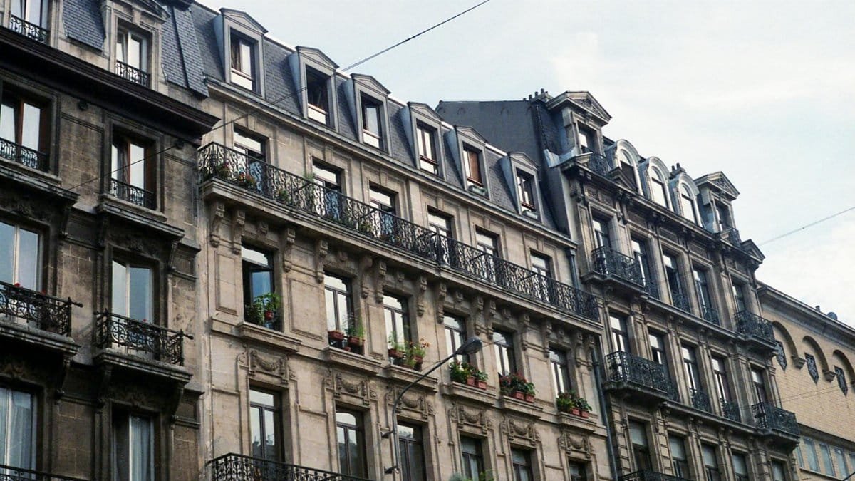 Facade of classic Brussels buildings featuring elegant iron balconies.