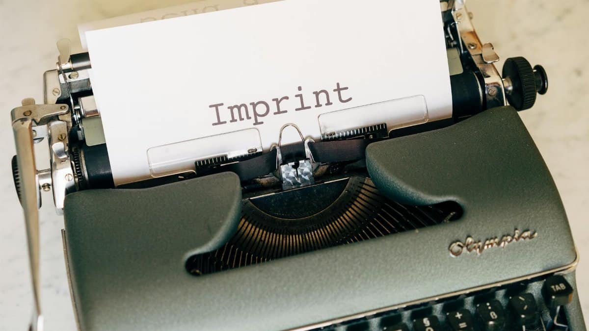 Close-up of a vintage typewriter with the word 'Imprint' on paper, conveying a retro feel.