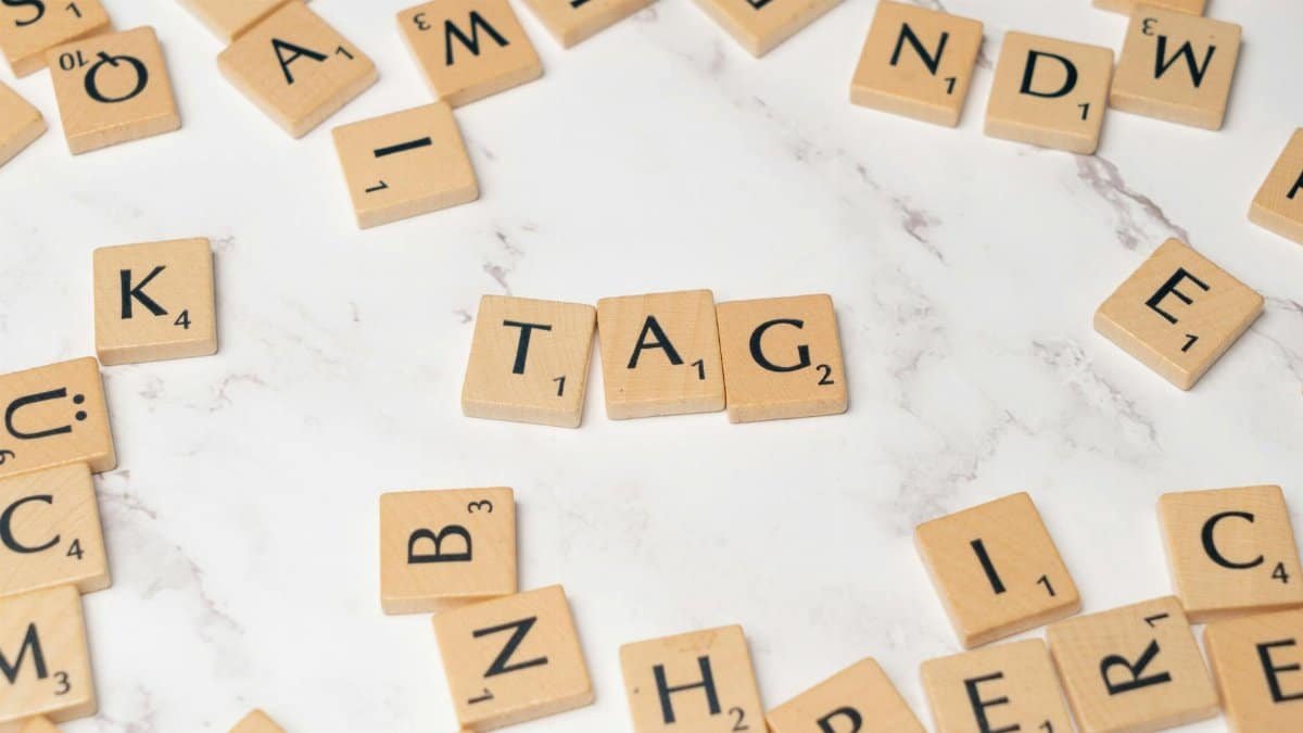 Stylish Scrabble tiles forming 'TAG' on a marble surface for creative projects.