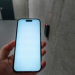 A smartphone unlocking a secure door using NFC technology in a modern building stairwell.