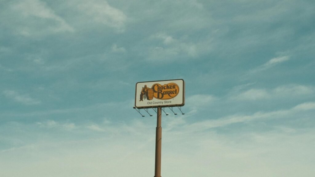 Cracker Barrel signpost with a clear blue sky background in Valdosta, GA, USA.