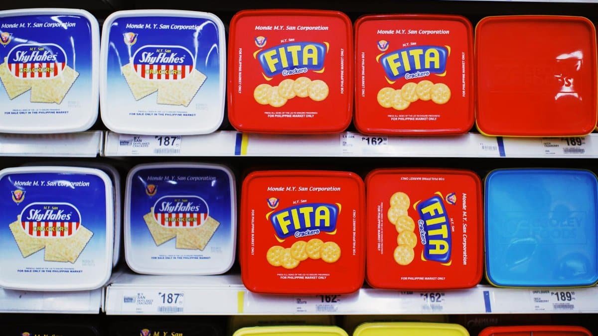 Assorted cracker packages displayed on supermarket shelf, showcasing vibrant packaging designs.