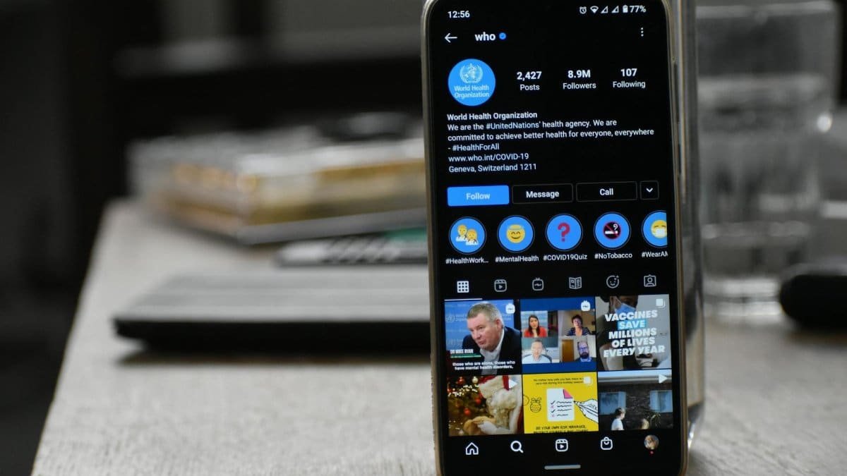 Close-up of a smartphone showing World Health Organization's Instagram profile indoors.