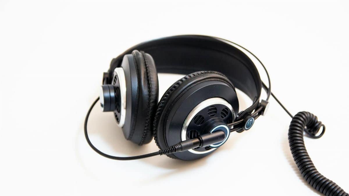 Studio-quality black headphones with coiled cable on a clean white background.