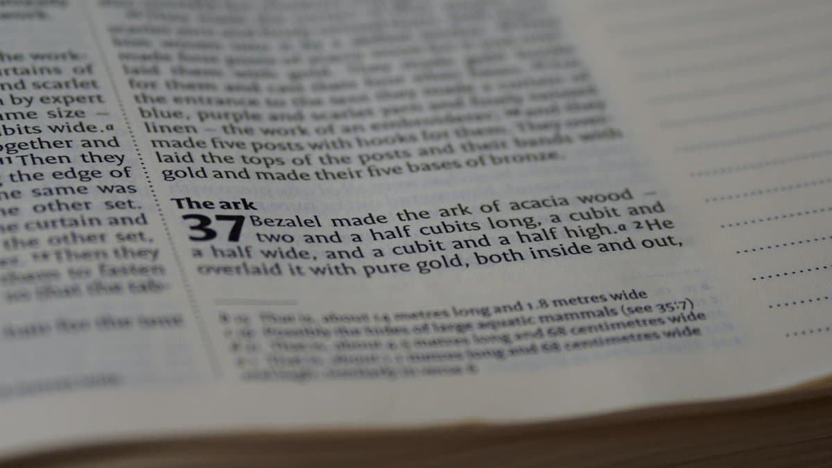 Detailed close-up view of text from a religious book, depicting religious scripture.