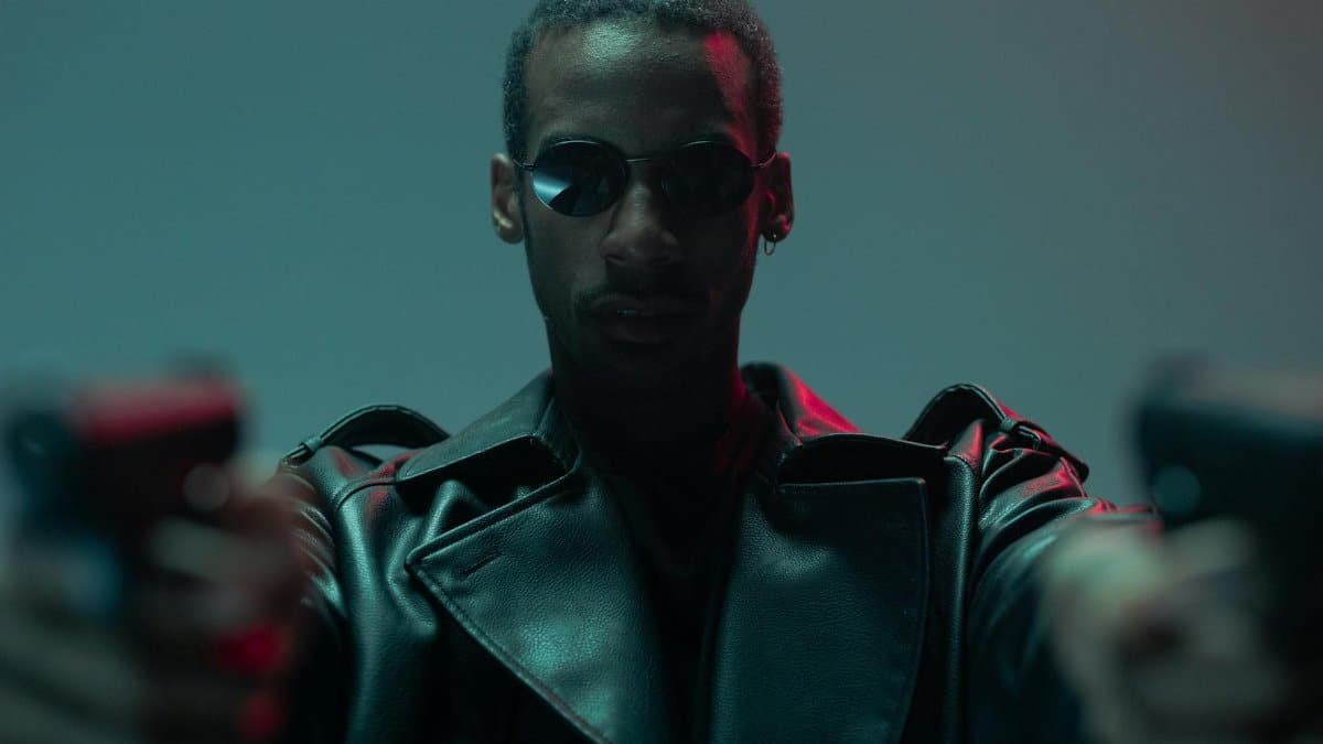 A cool and conceptual portrait featuring a black man in sunglasses and a leather jacket.