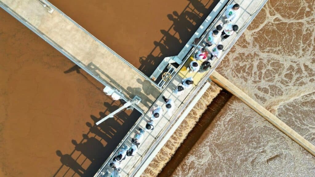 Aerial view of people touring an industrial water treatment facility in Langfang, China.