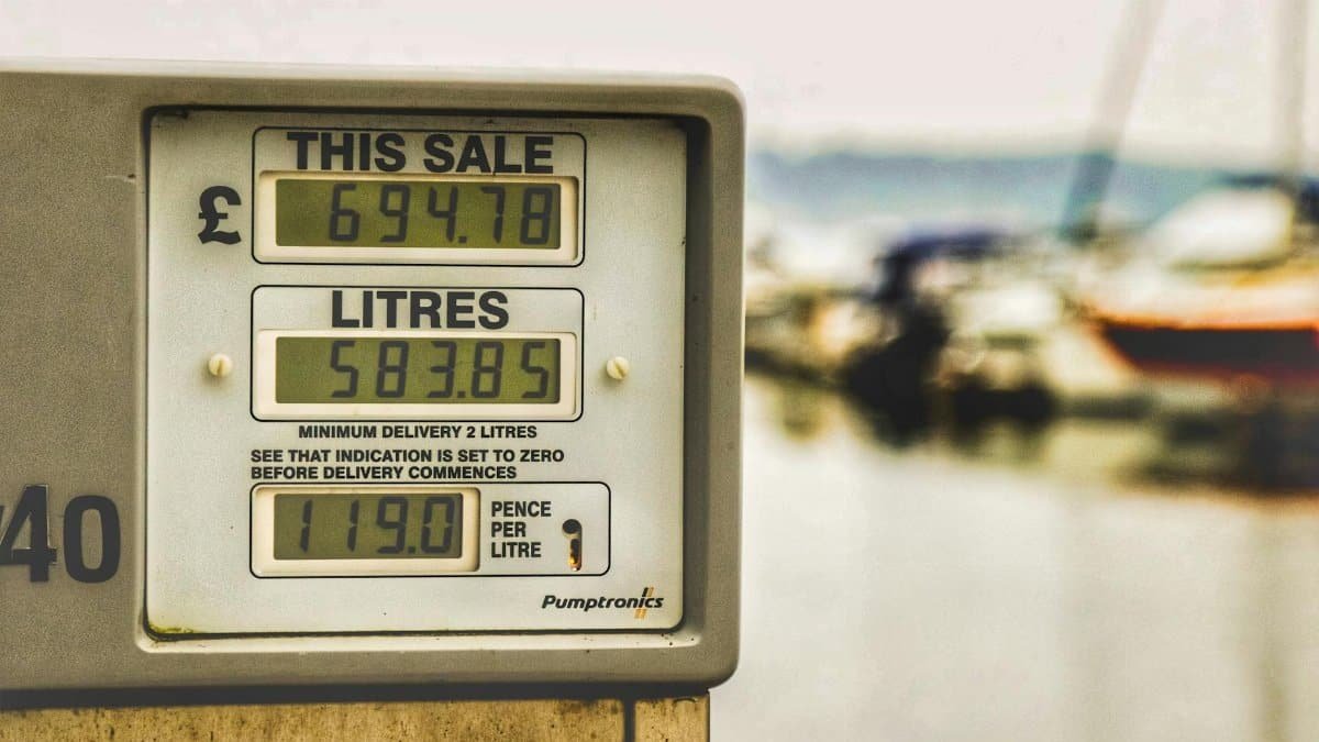 Blurred background view with focus on fuel pump display showing price and liters.
