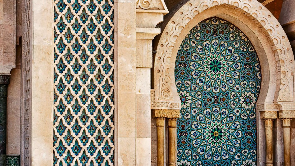 Detailed view of traditional Moorish tilework showcasing intricate patterns and vibrant colors in historic architecture.