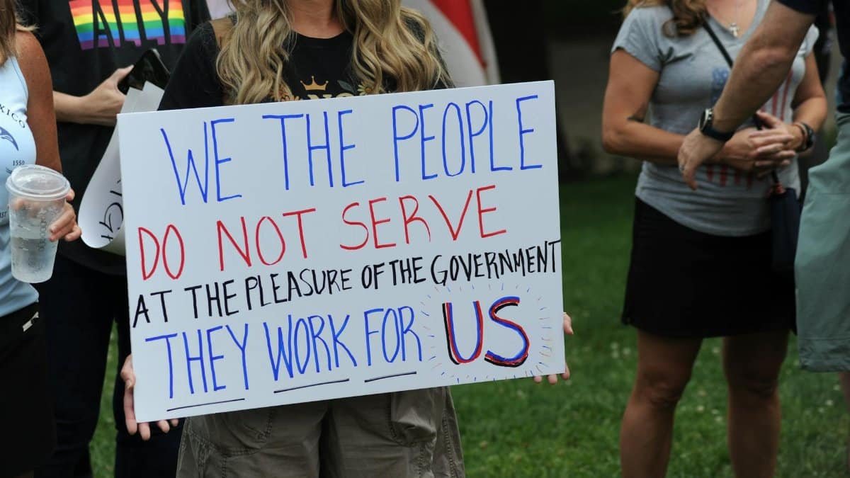 Protesters hold a sign stating governmental accountability at a rally in Baltimore.