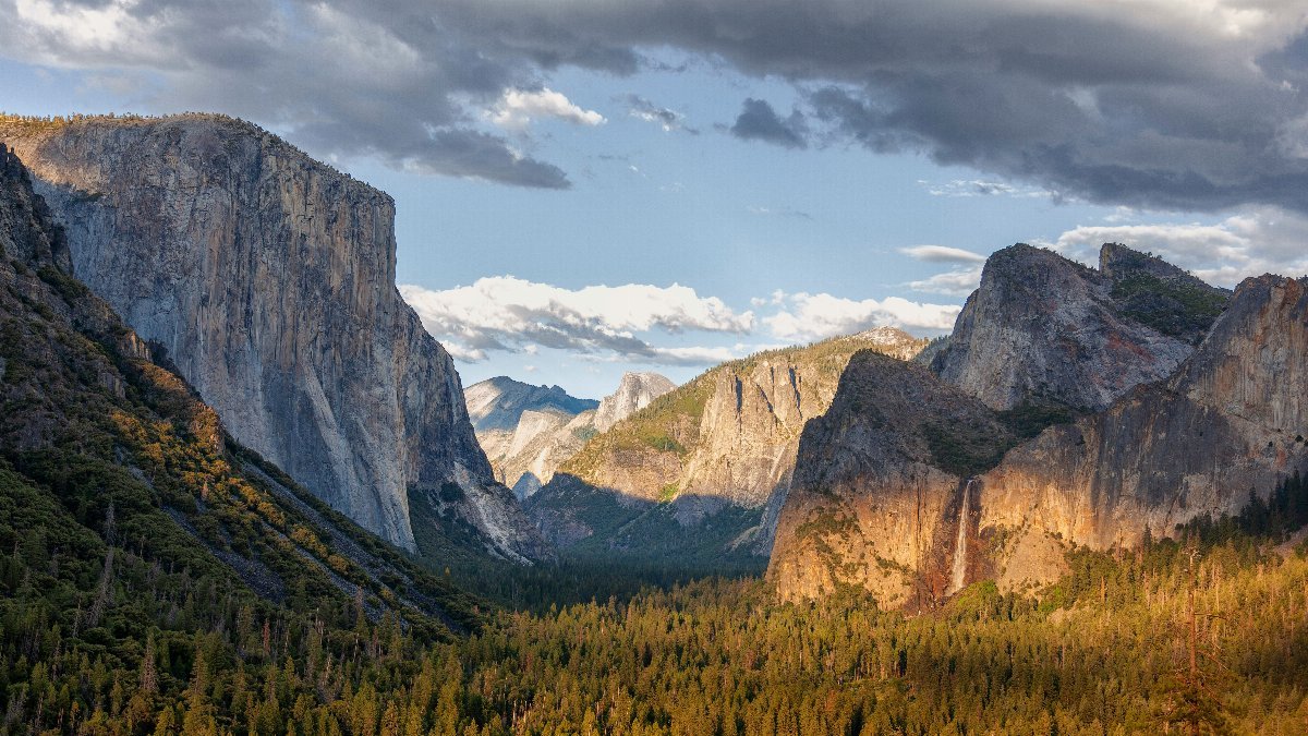 a view of a valley with mountains in the background