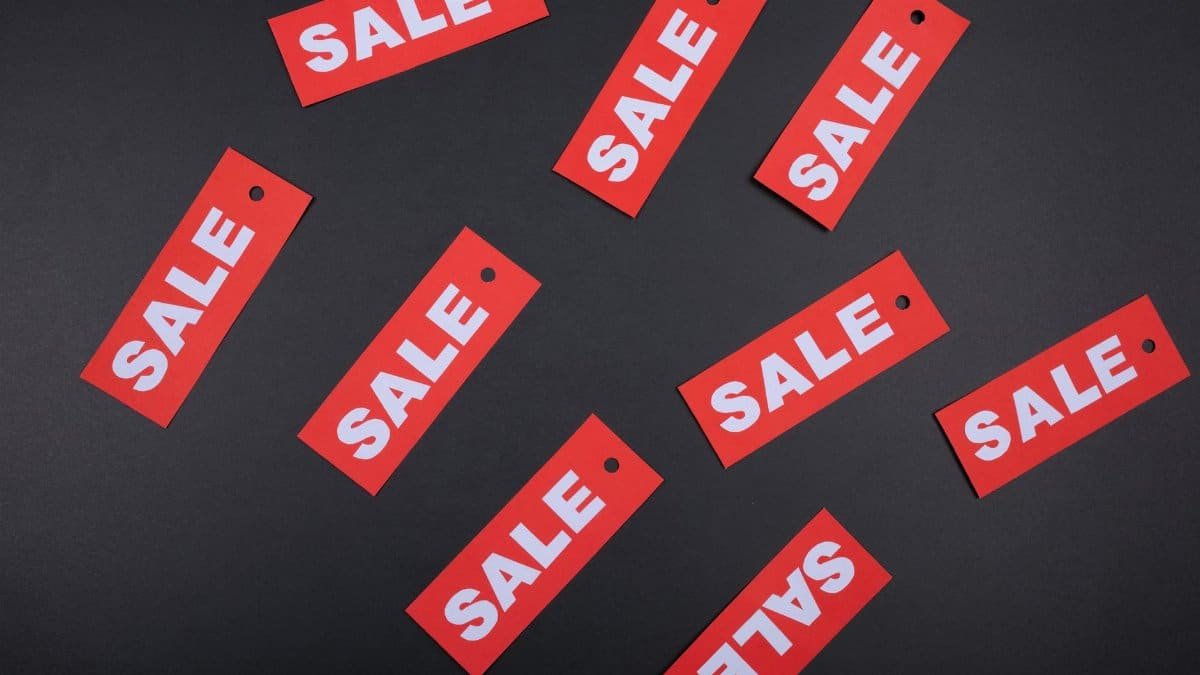 Top view of red sale tags on a black surface, perfect for marketing promotions.