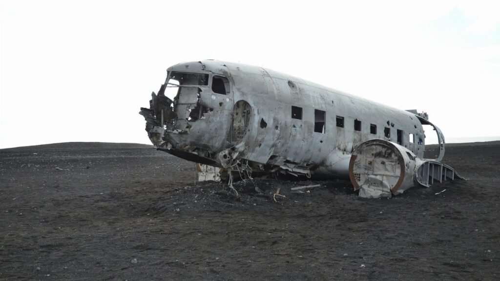 A crashed aircraft wreckage in a deserted landscape, evoking mystery and history.
