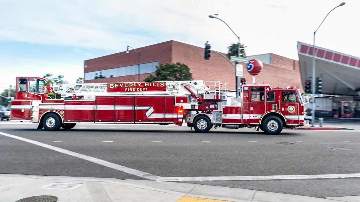Beverly Hills fire truck driving through a city street, showcasing emergency services in action.