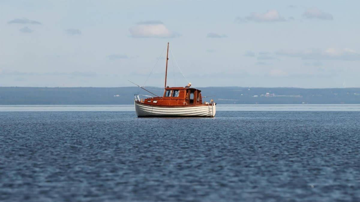 A peaceful scene of a wooden boat on Lake Vättern, Jönköping, Sweden.