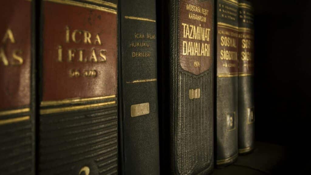 Detailed close-up of law and regulation books on a bookshelf, emphasizing education and knowledge.