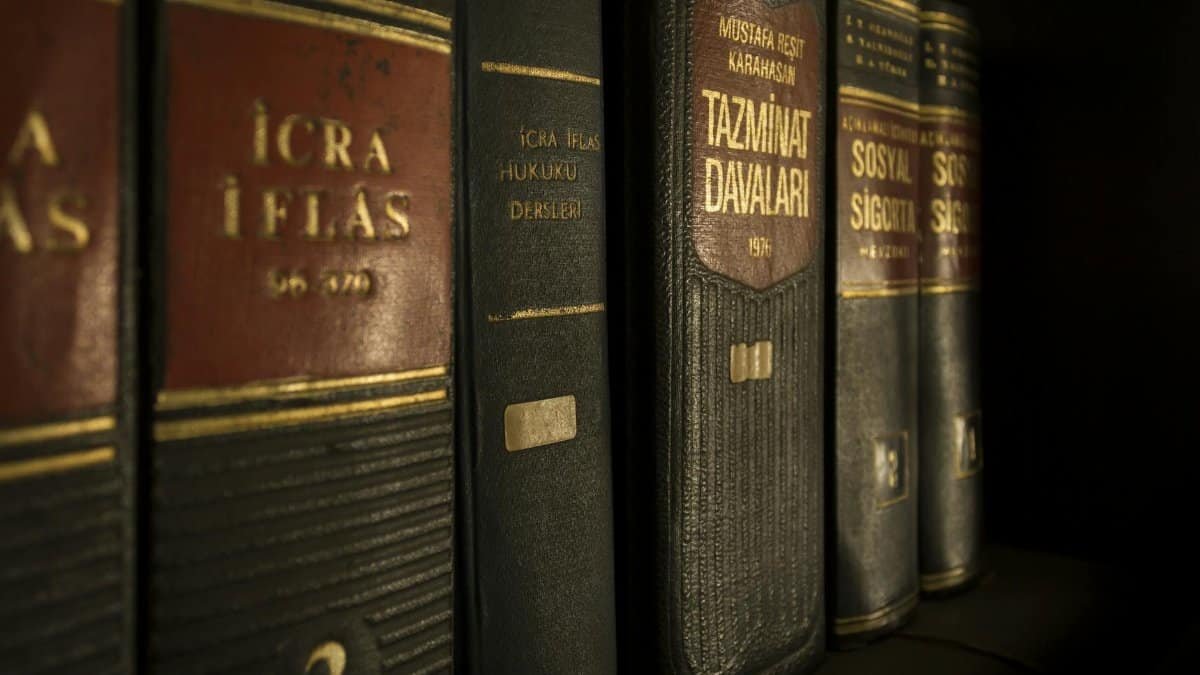 Detailed close-up of law and regulation books on a bookshelf, emphasizing education and knowledge.