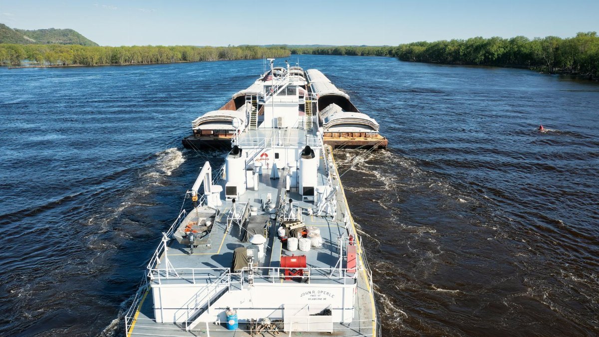 Aerial view of a barge navigating the Mississippi River, capturing the essence of water transport.