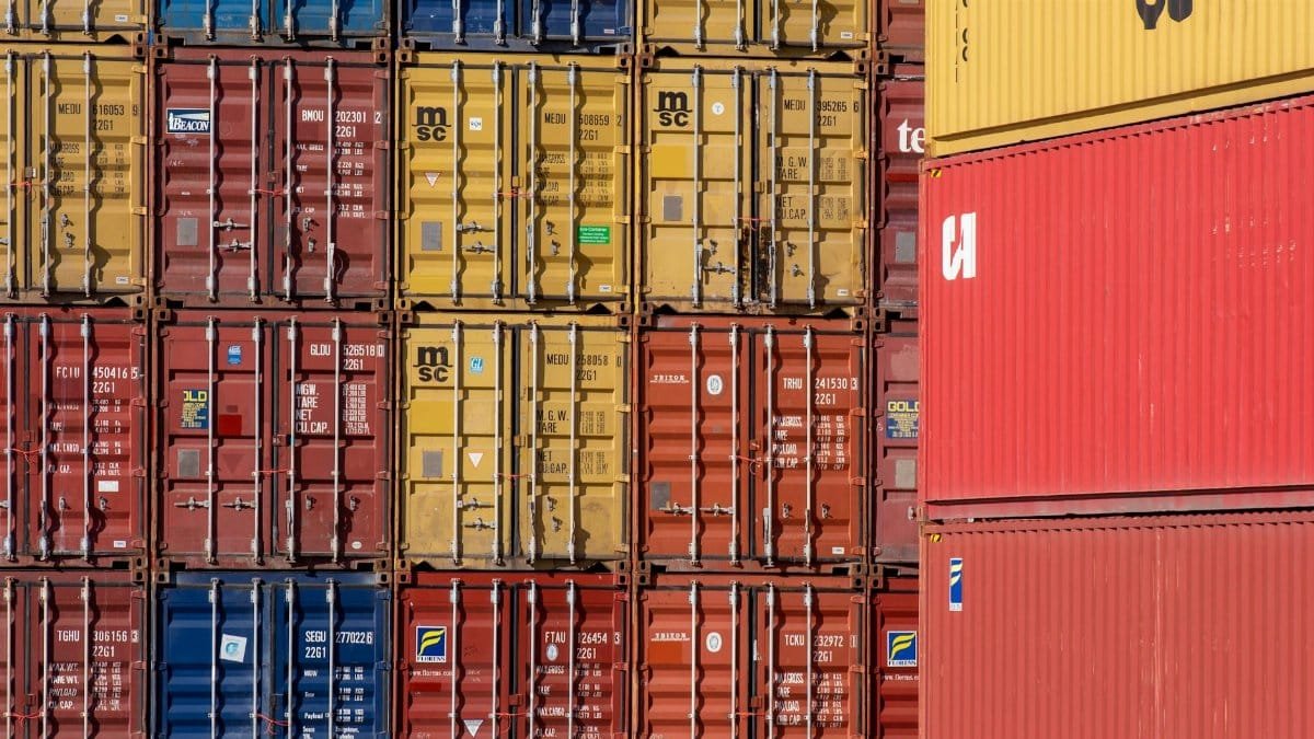 Colorful shipping containers stacked in a port for transport logistics.
