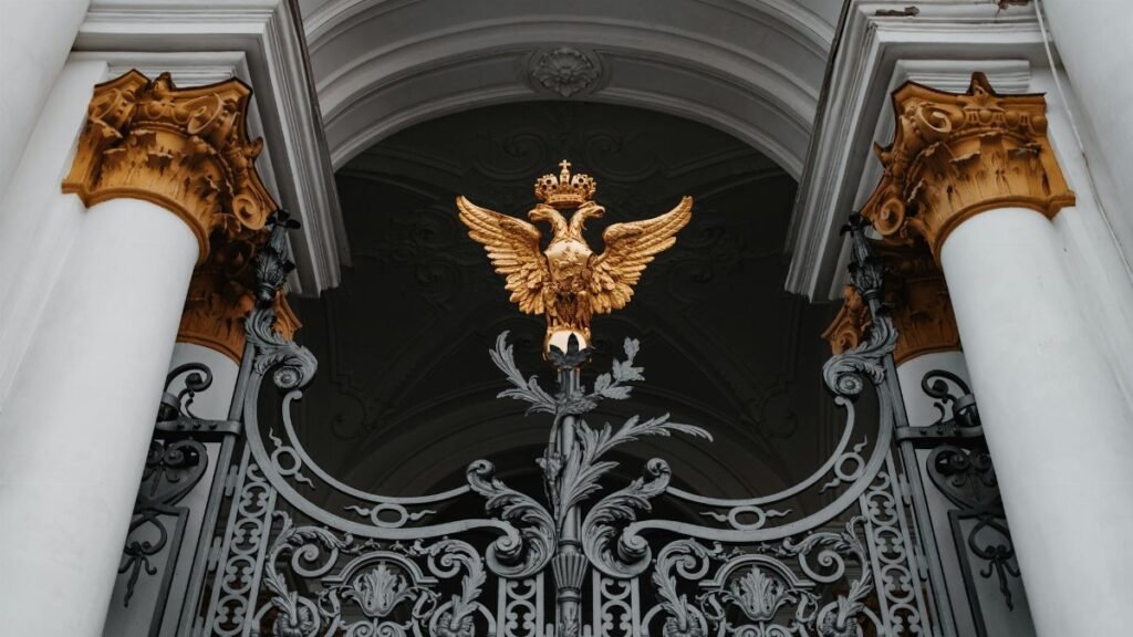 Intricate gate with a golden double-headed eagle at the Winter Palace, Saint Petersburg, Russia.