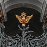 Intricate gate with a golden double-headed eagle at the Winter Palace, Saint Petersburg, Russia.