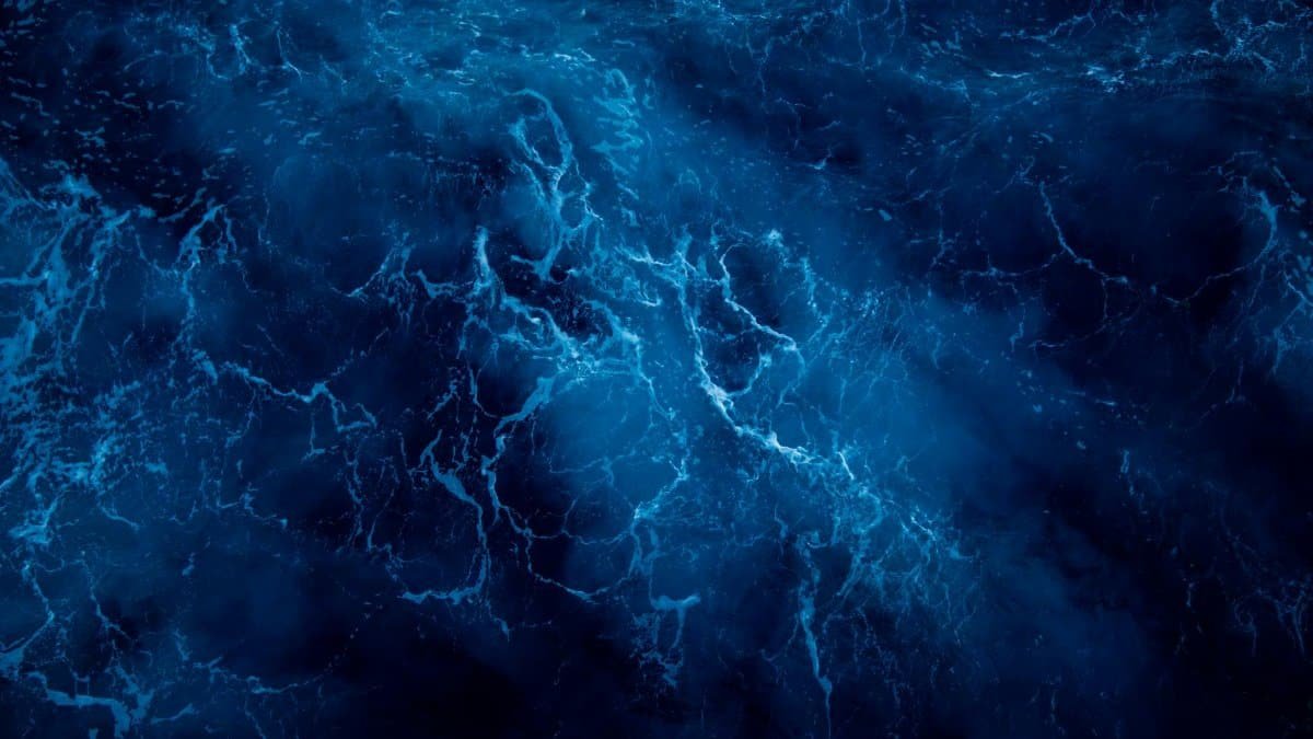 A breathtaking aerial view of deep blue ocean waves showcasing natural beauty and dynamic water patterns.