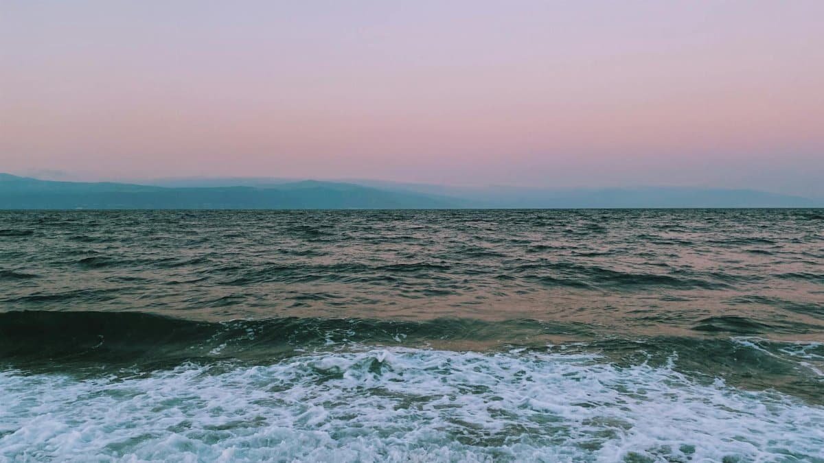 Capture the calmness of the sea at twilight with a pink horizon in Bursa, Türkiye.