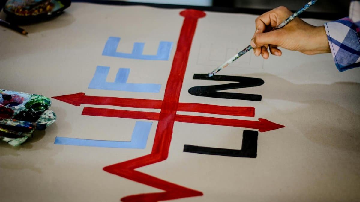 Close-up of colorful hand-painted lifeline arrow artwork symbolizing creativity and design.