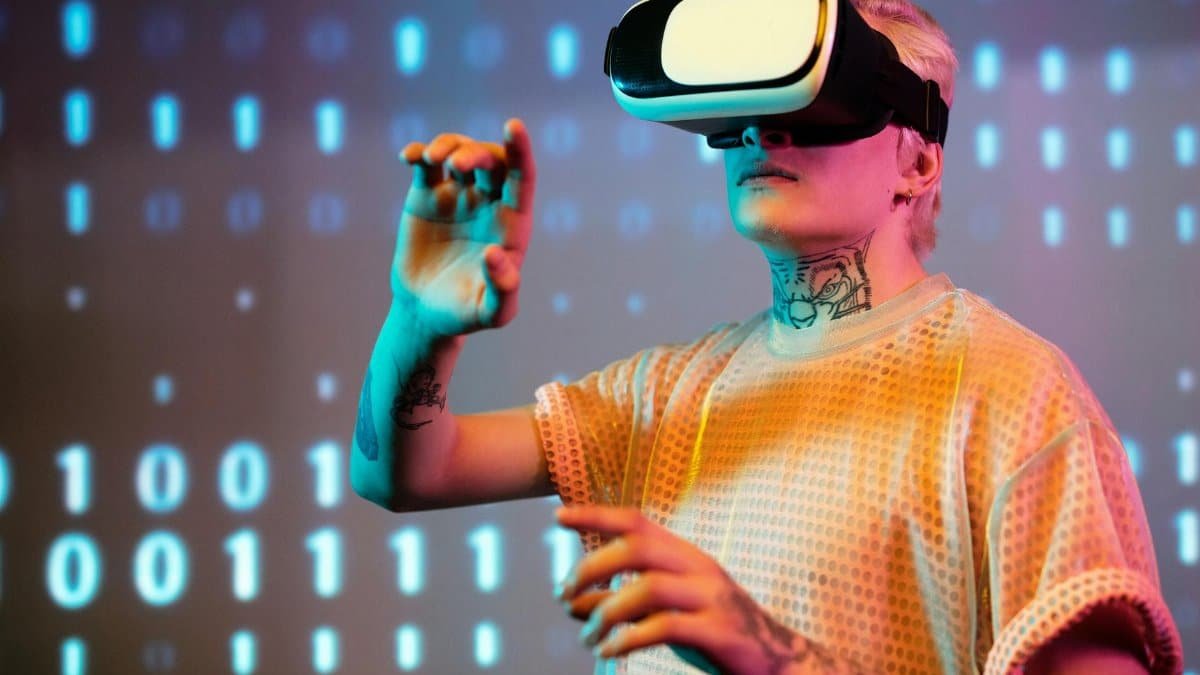 A young man interacts in virtual reality wearing a headset with a digital binary background.