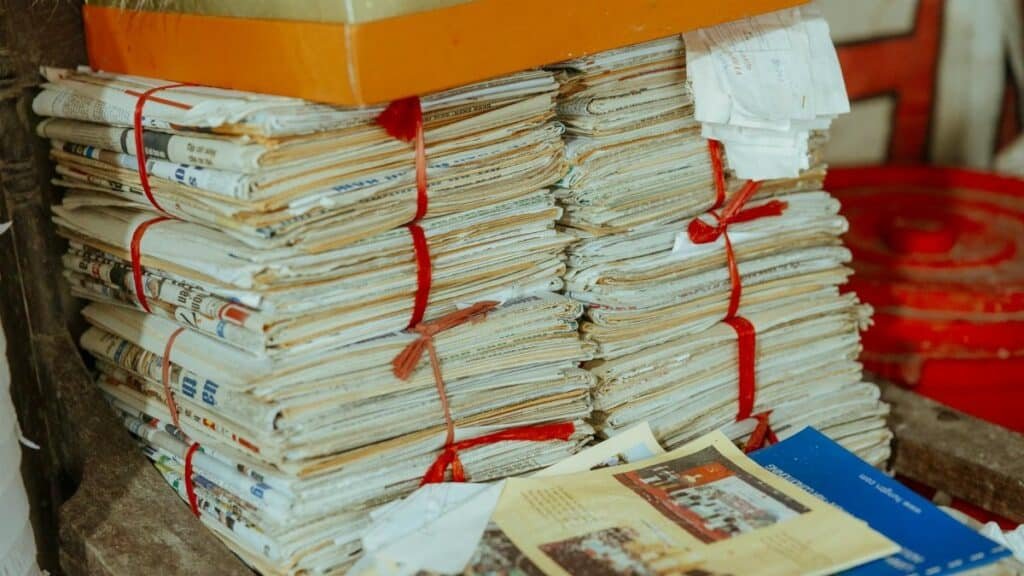 Bundles of newspapers bound together, showcasing vintage reading material.