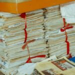 Bundles of newspapers bound together, showcasing vintage reading material.