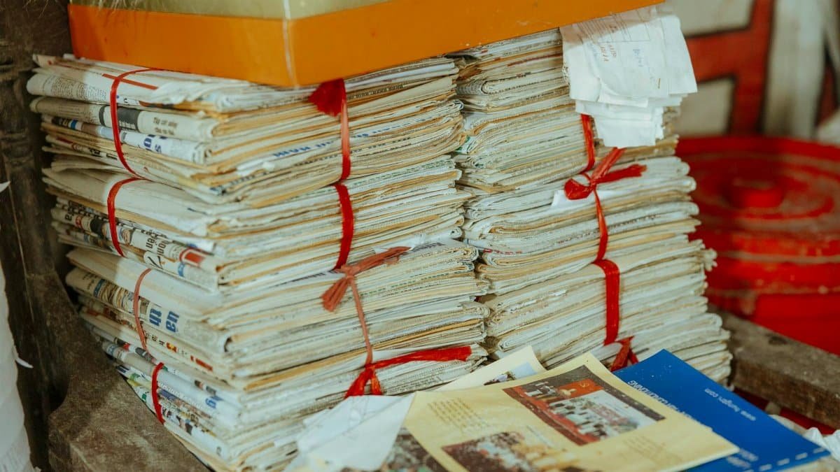 Bundles of newspapers bound together, showcasing vintage reading material.