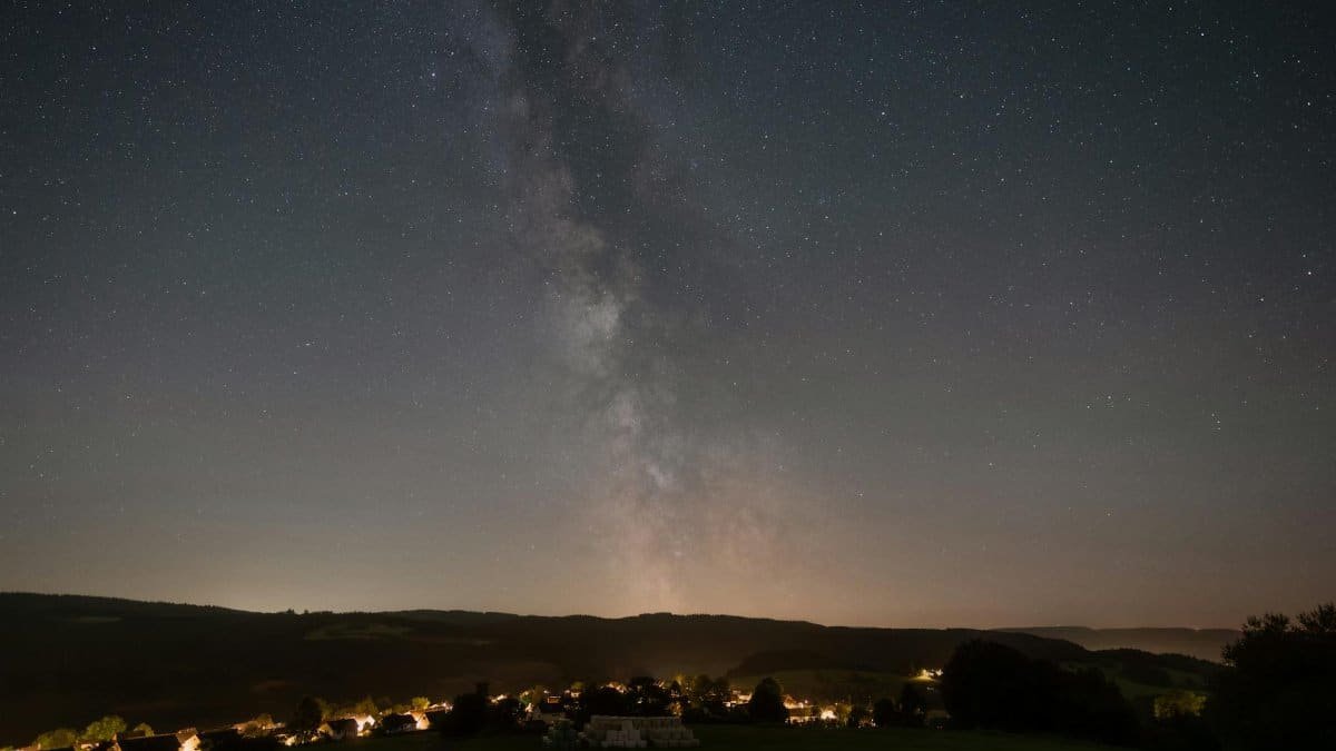 Milky Way galaxy shines brightly over the serene village of Gerolstein, Germany.