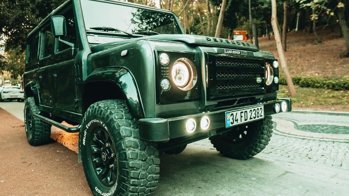 A rugged Land Rover Defender SUV parked on a street in Istanbul, showcasing its robust design.