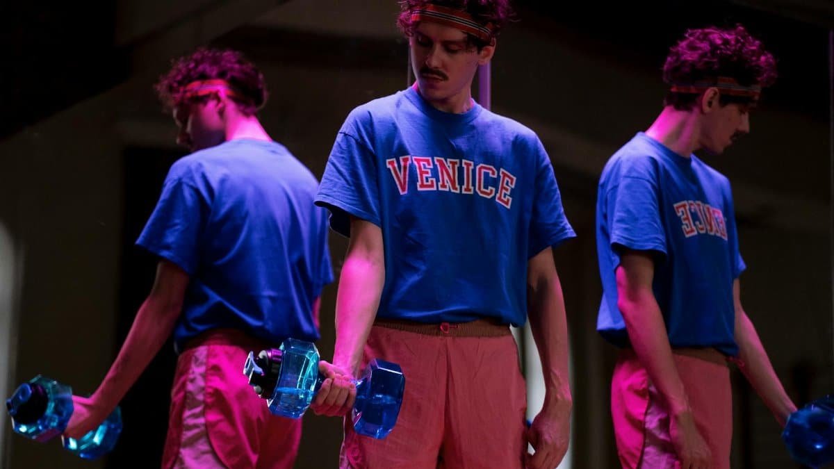 Man lifting dumbbells in front of a mirror, promoting fitness and healthy lifestyle.