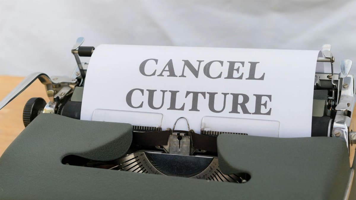 Close-up of a vintage typewriter with paper reading 'Cancel Culture', signifying social media trends.