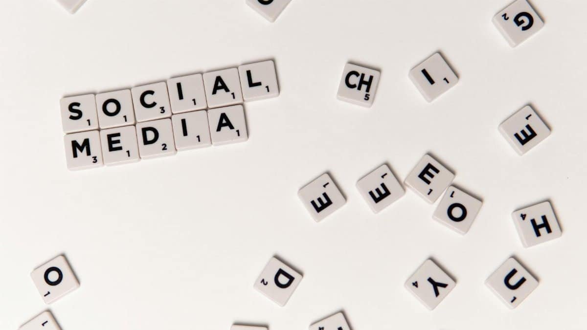 Scrabble tiles spelling 'Social Media' on a white background, symbolizing digital communication.
