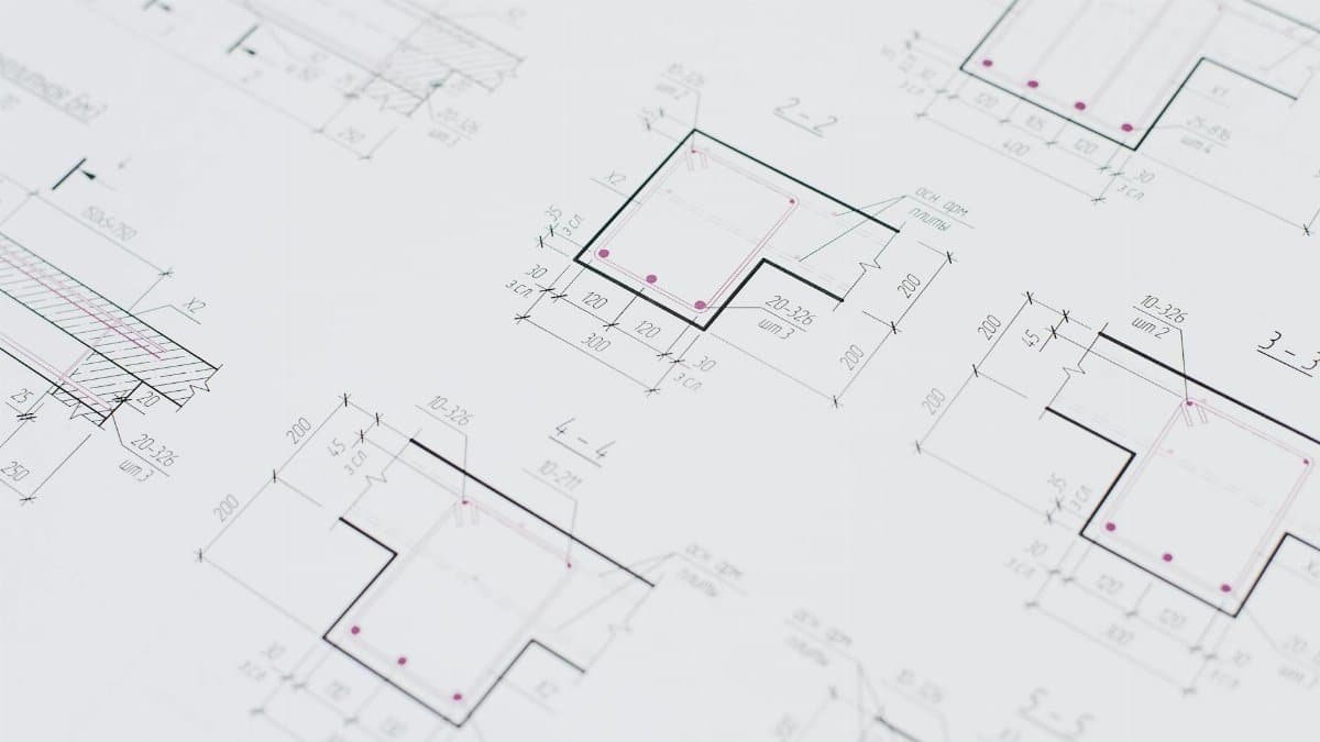 High-resolution close-up of detailed architectural blueprints showcasing precision design layouts.
