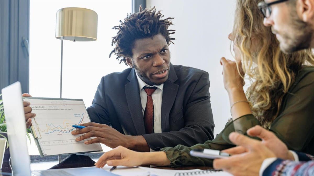 Business professionals discussing financial data during a collaborative meeting.